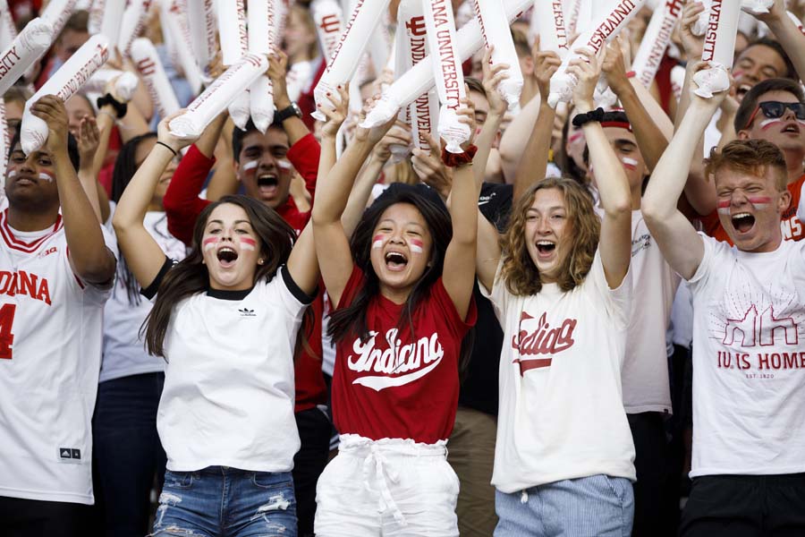 A group of students cheer at a game